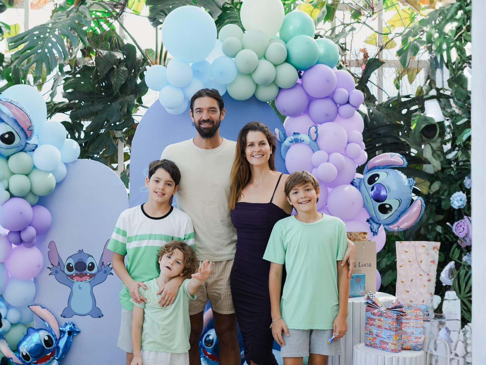 Family standing at a pastel balloon photozone