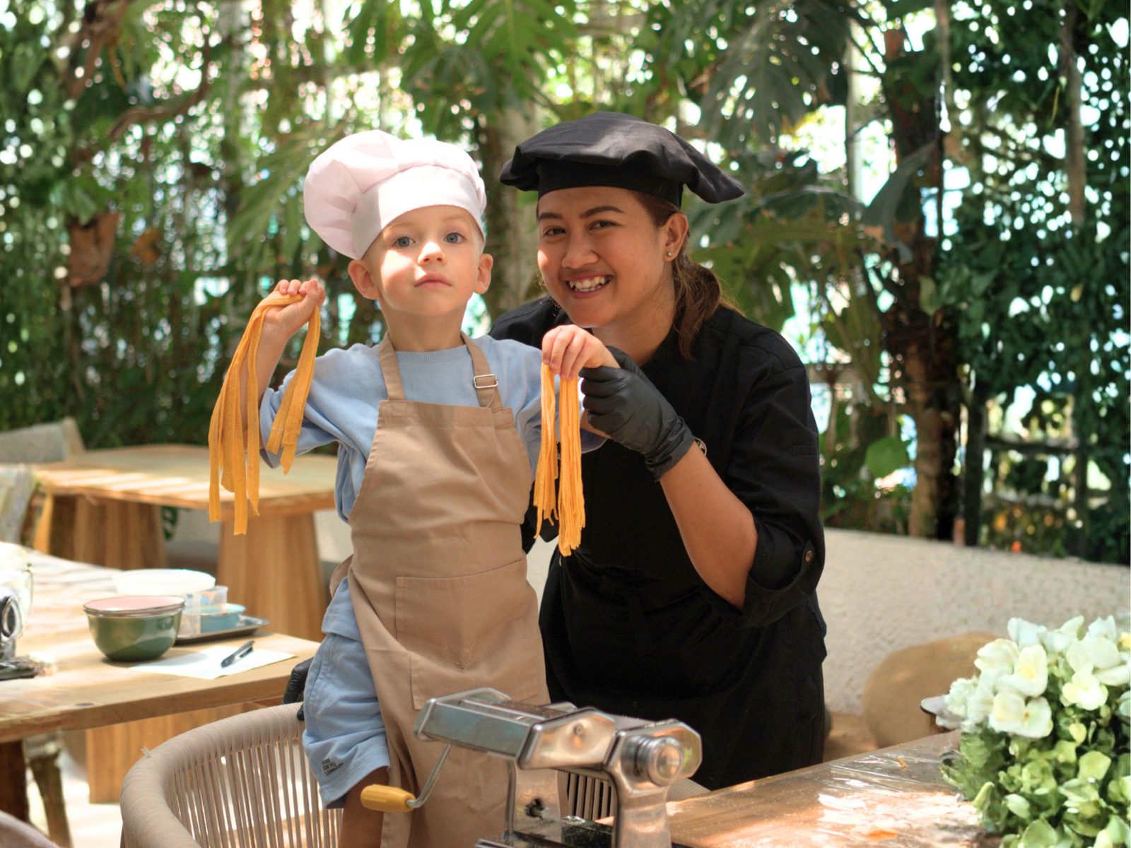 Adult and child in aprons at a cooking class